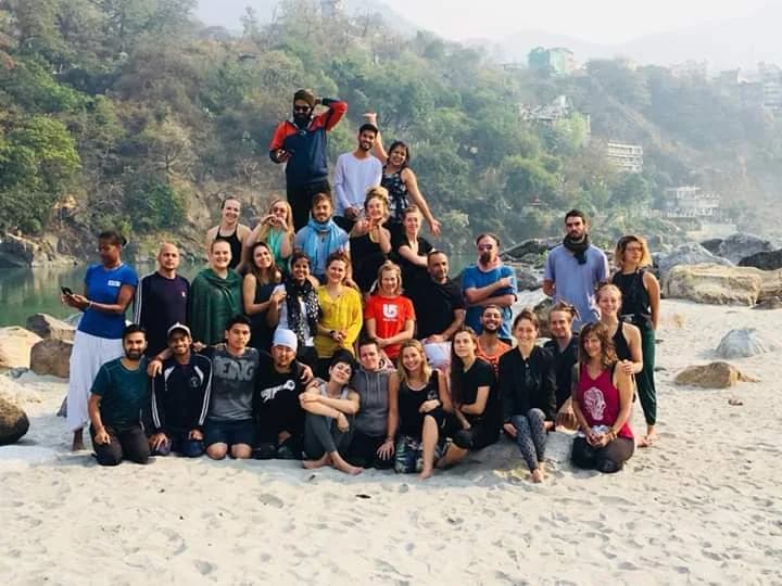 Deep Yoga cohort photographed together on the western bank of the Ganges in Rishikesh